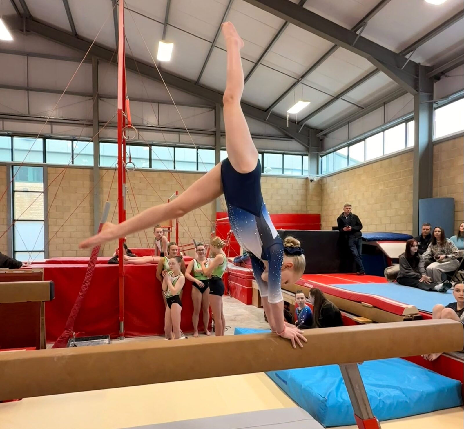 Maldon gymnast in a handstand on the beam